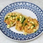Tacos filled with creamy queso chicken and toppings