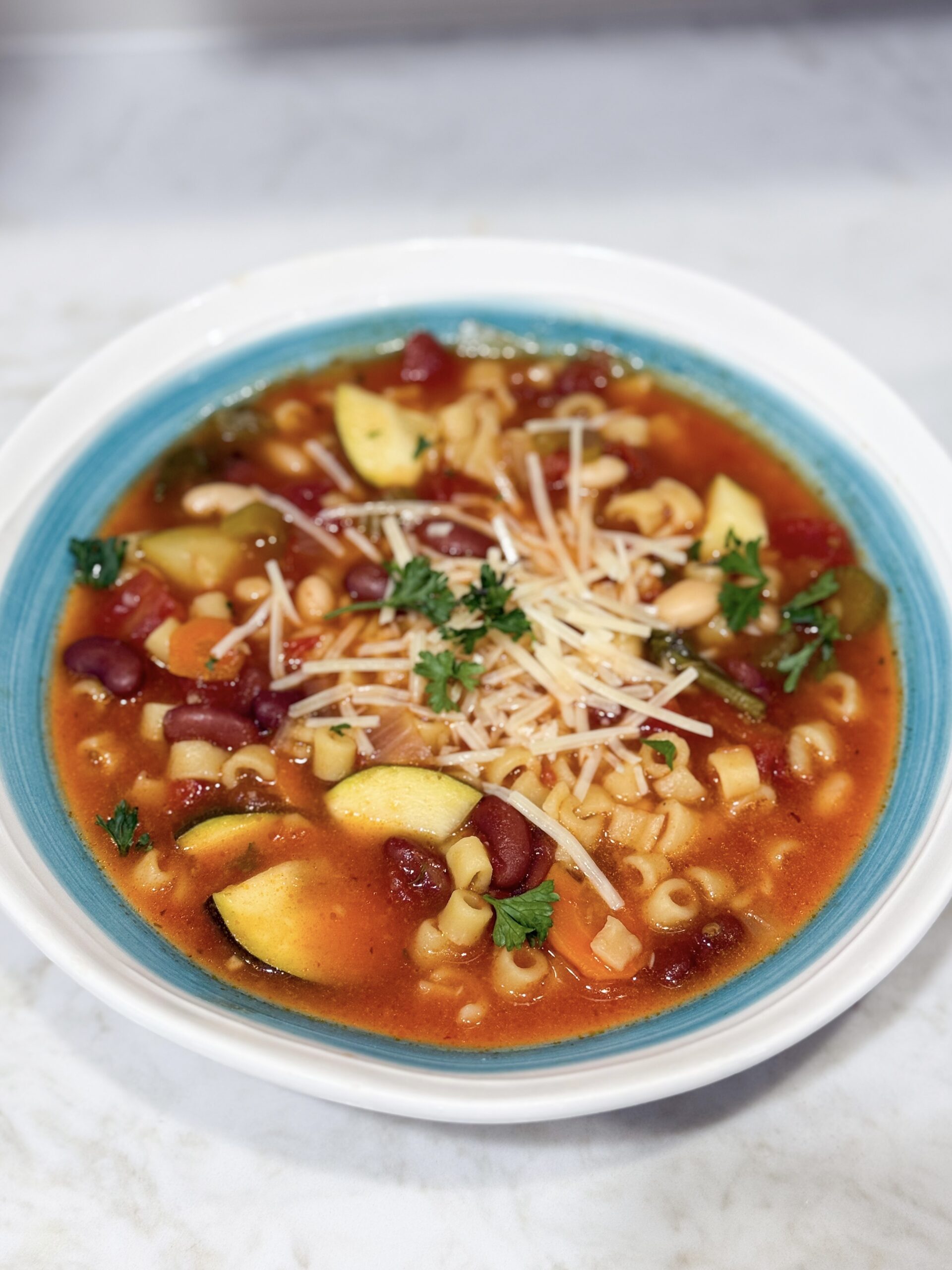 Slow cooker minestrone soup in bowl with Parmesan
