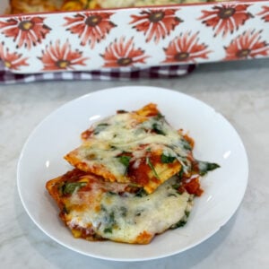 Baked cheese ravioli casserole topped with herbs and melted cheese
