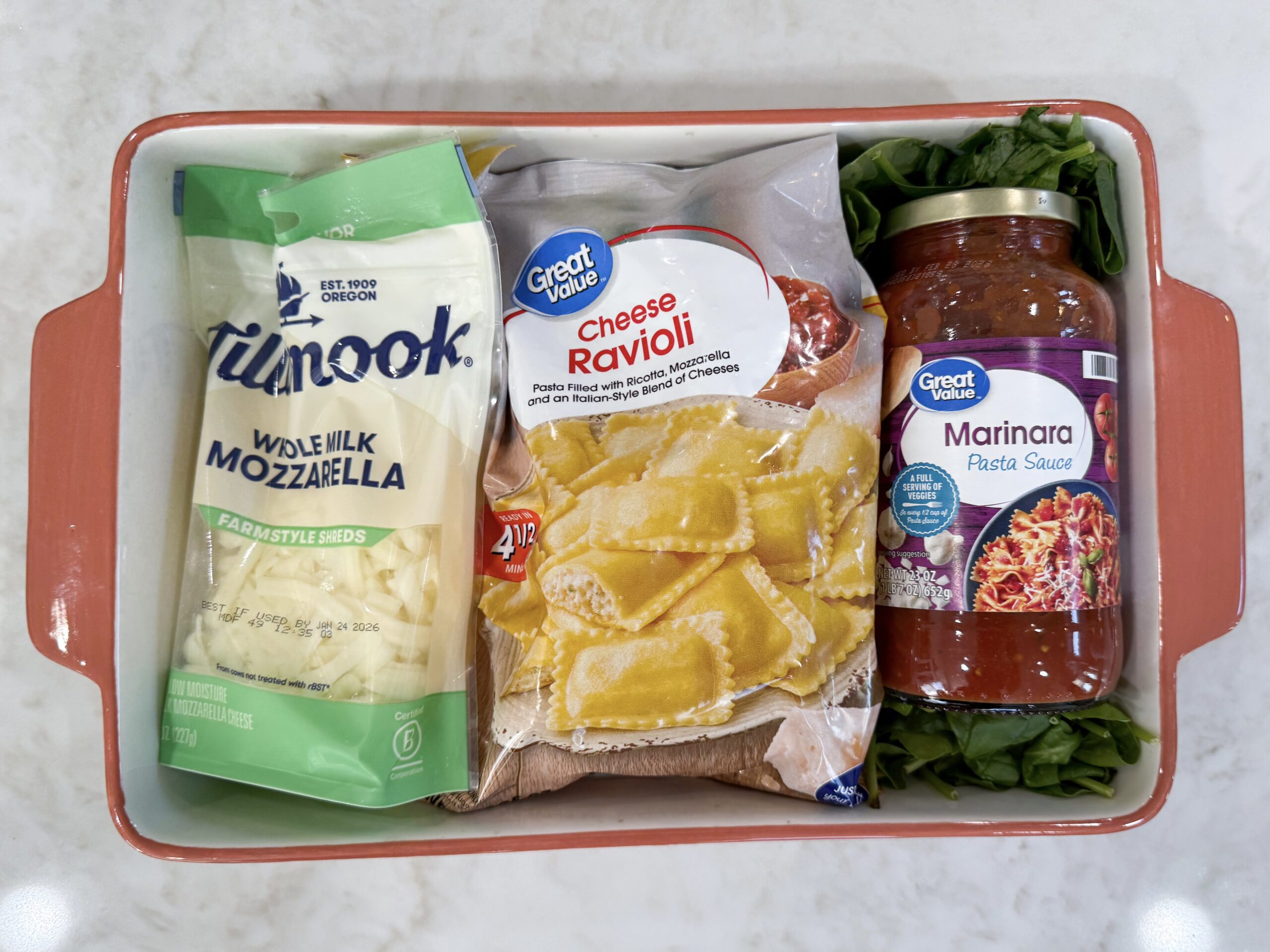 Ingredients for cheese ravioli bake in casserole dish