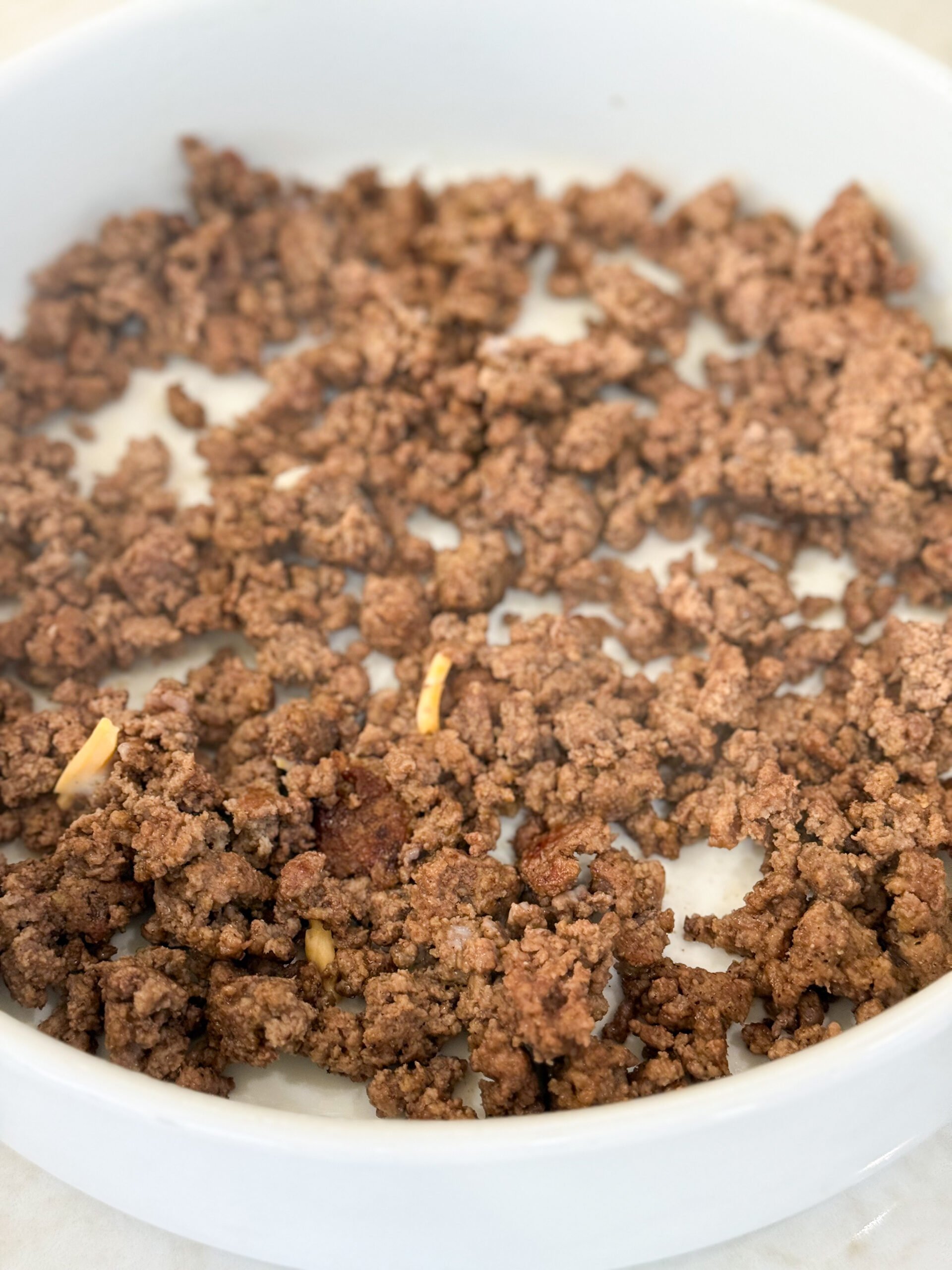 Browned ground beef added to bottom of casserole dish