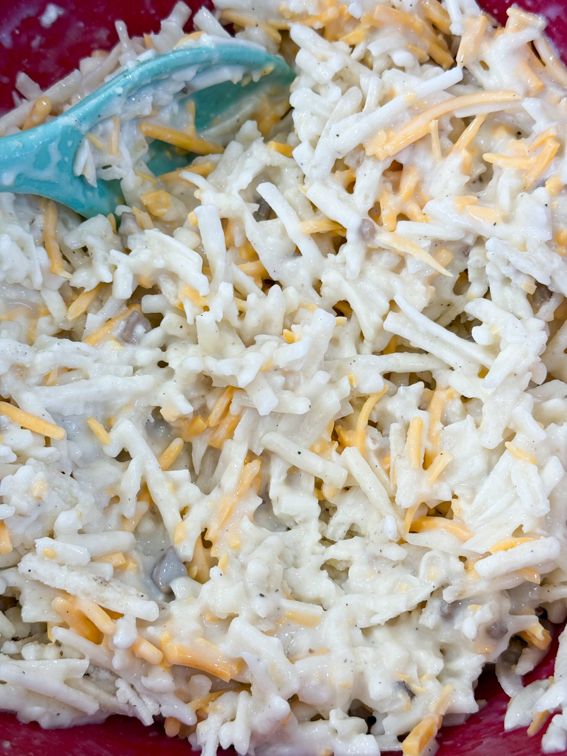 Mixing hashbrown mixture with cheese and soup