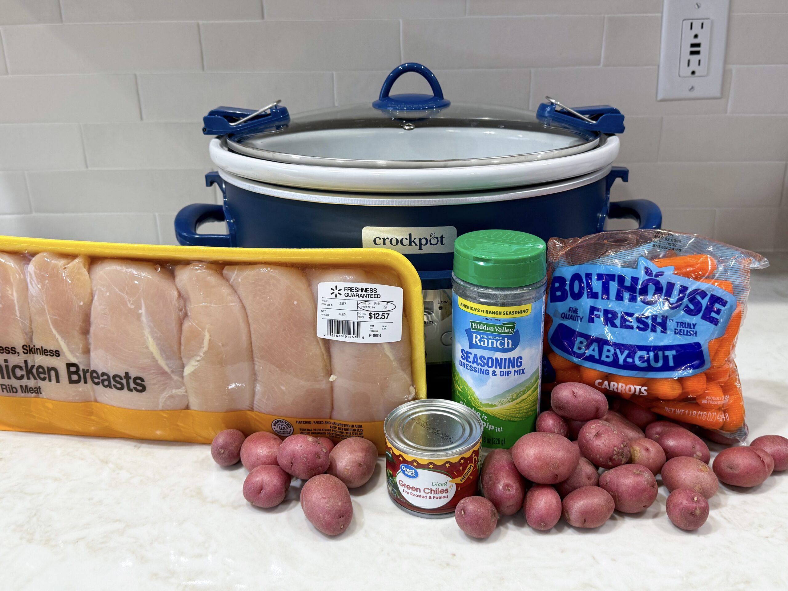 Ingredients for green chili ranch chicken on a counter.