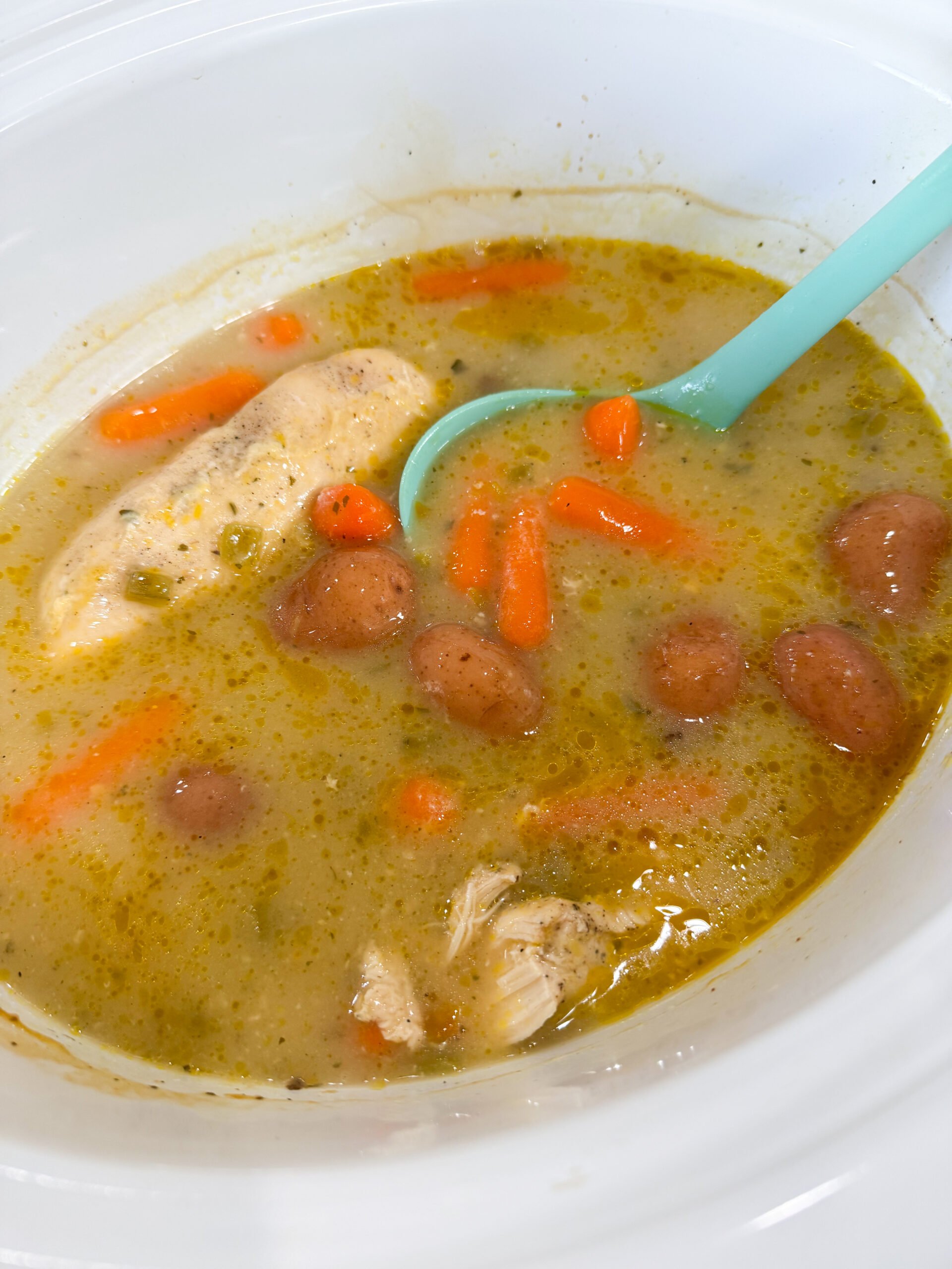 finished creamy green chili ranch chicken in slow cooker