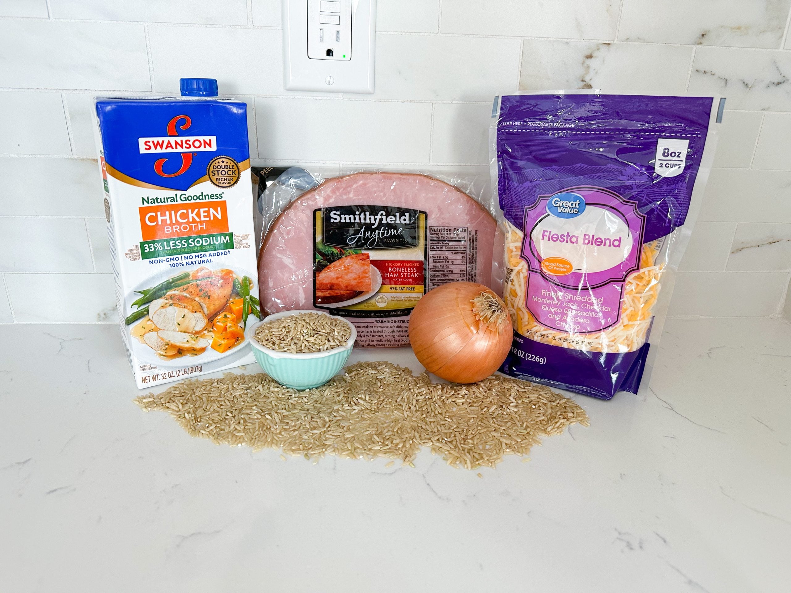 ham, rice, broccoli, cheese, and seasonings on a counter