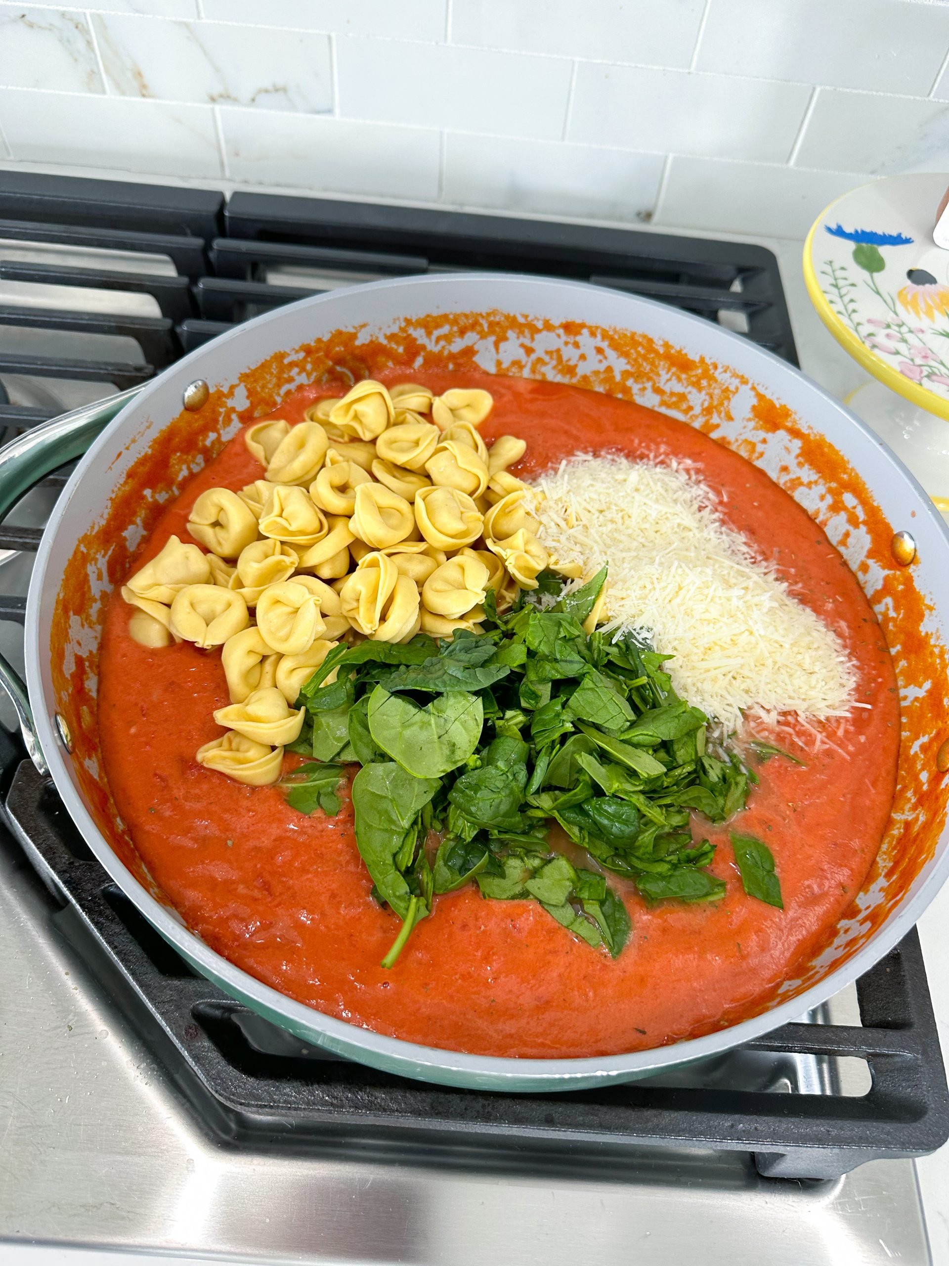 tortellini, spinach, and parmesan added to the sauce