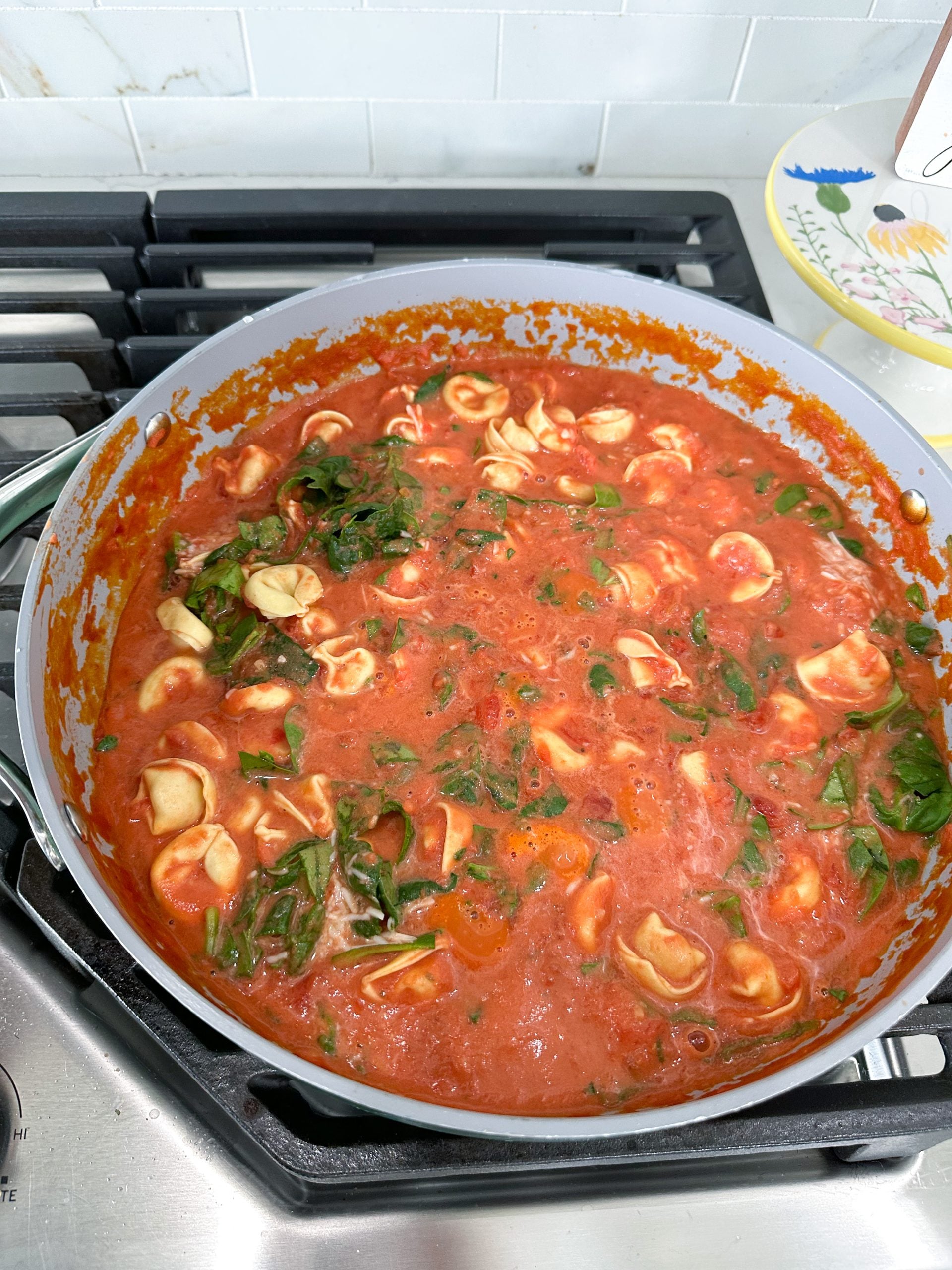 finished tortellini with spinach and Parmesan in skillet