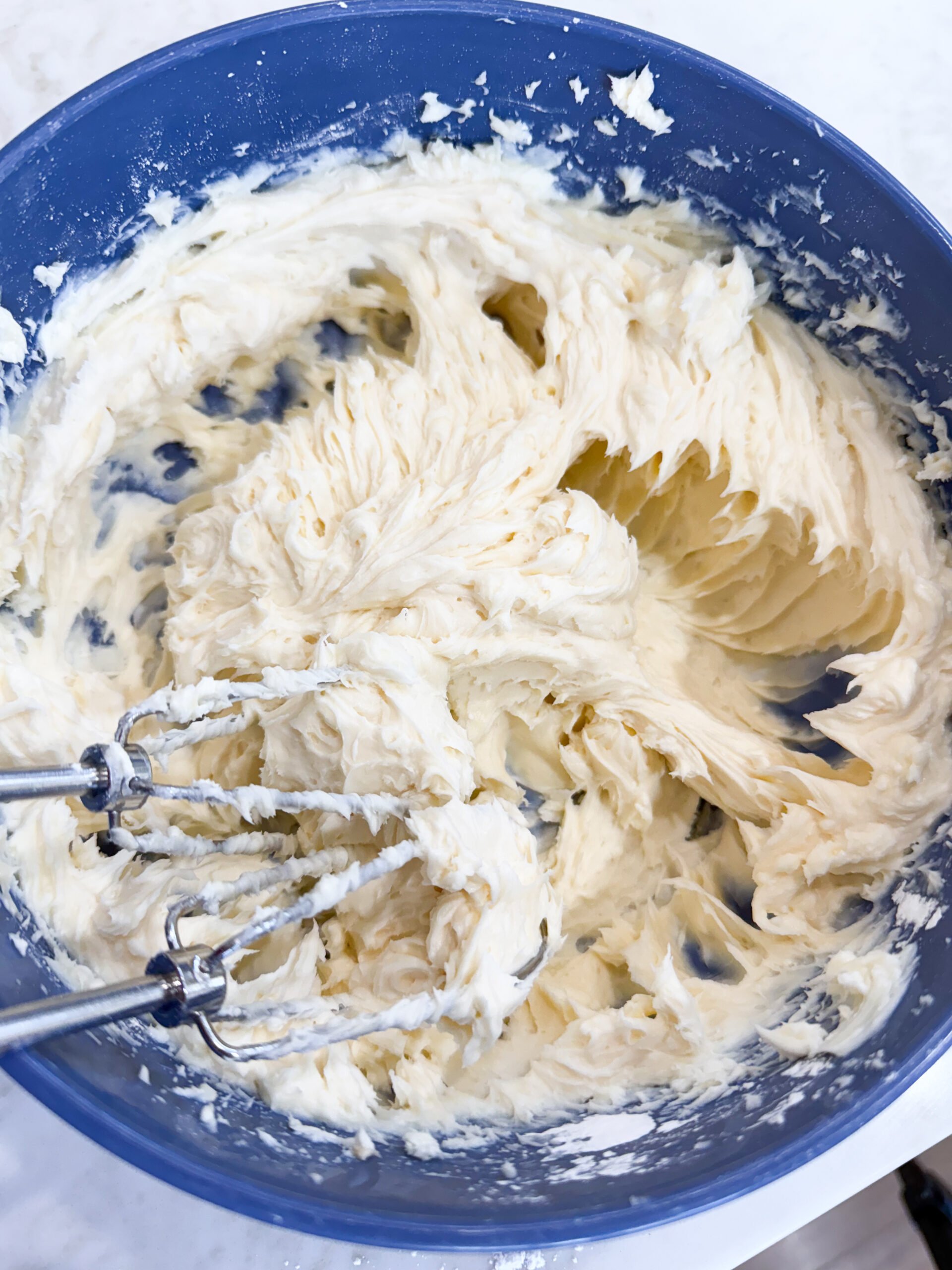 Cream cheese, vanilla, lemon juice, and powdered sugar combined in a bowl