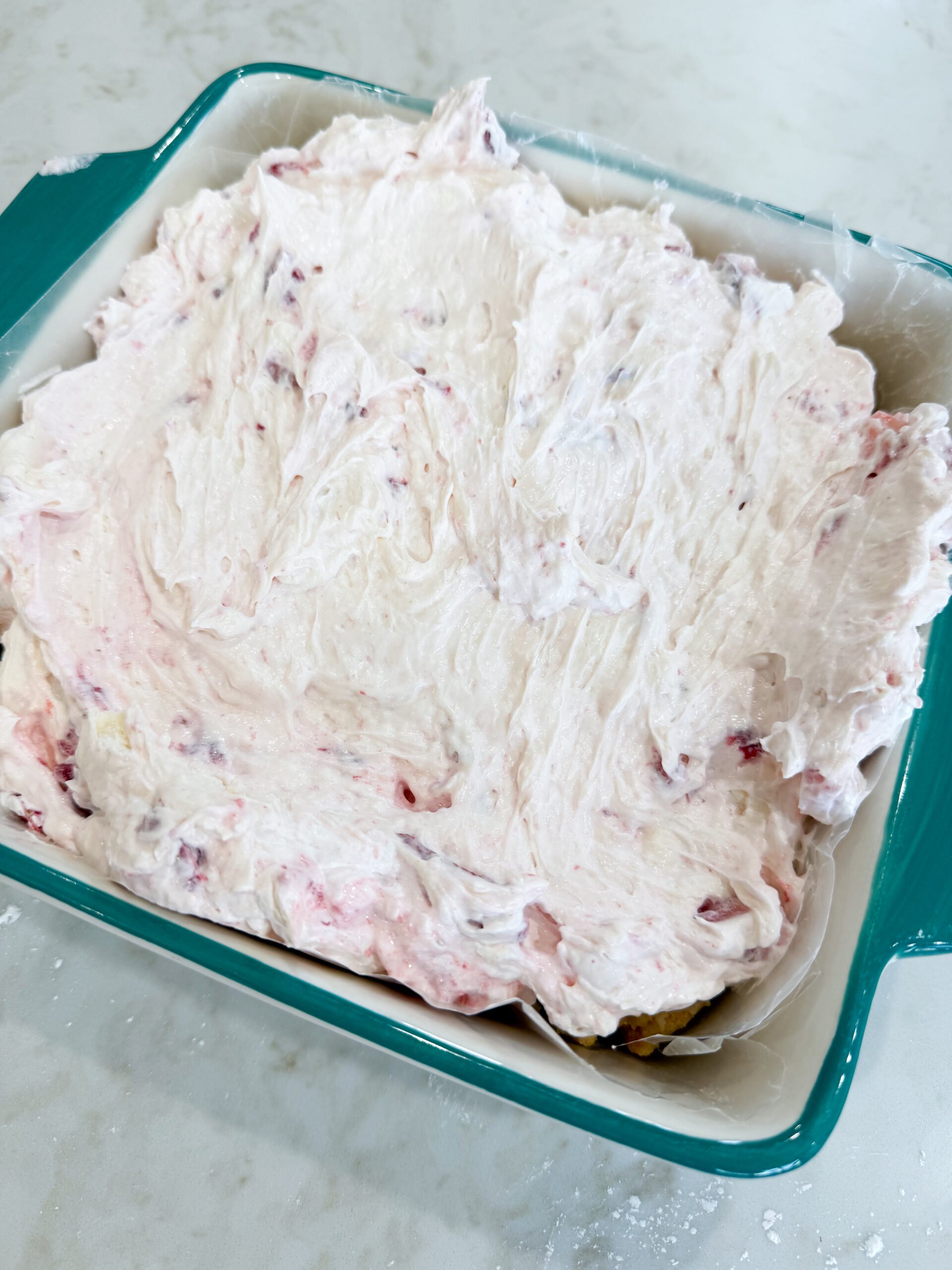 Strawberry cheesecake mixture spread over the crust