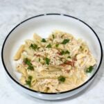 Slow cooker creamy chicken pasta topped with parsley