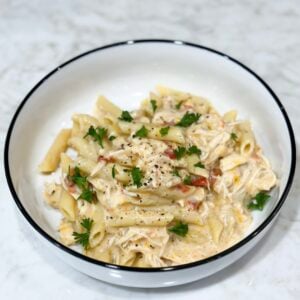 Slow cooker creamy chicken pasta topped with parsley