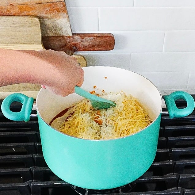 Tomato and Alfredo sauce simmering in a pot