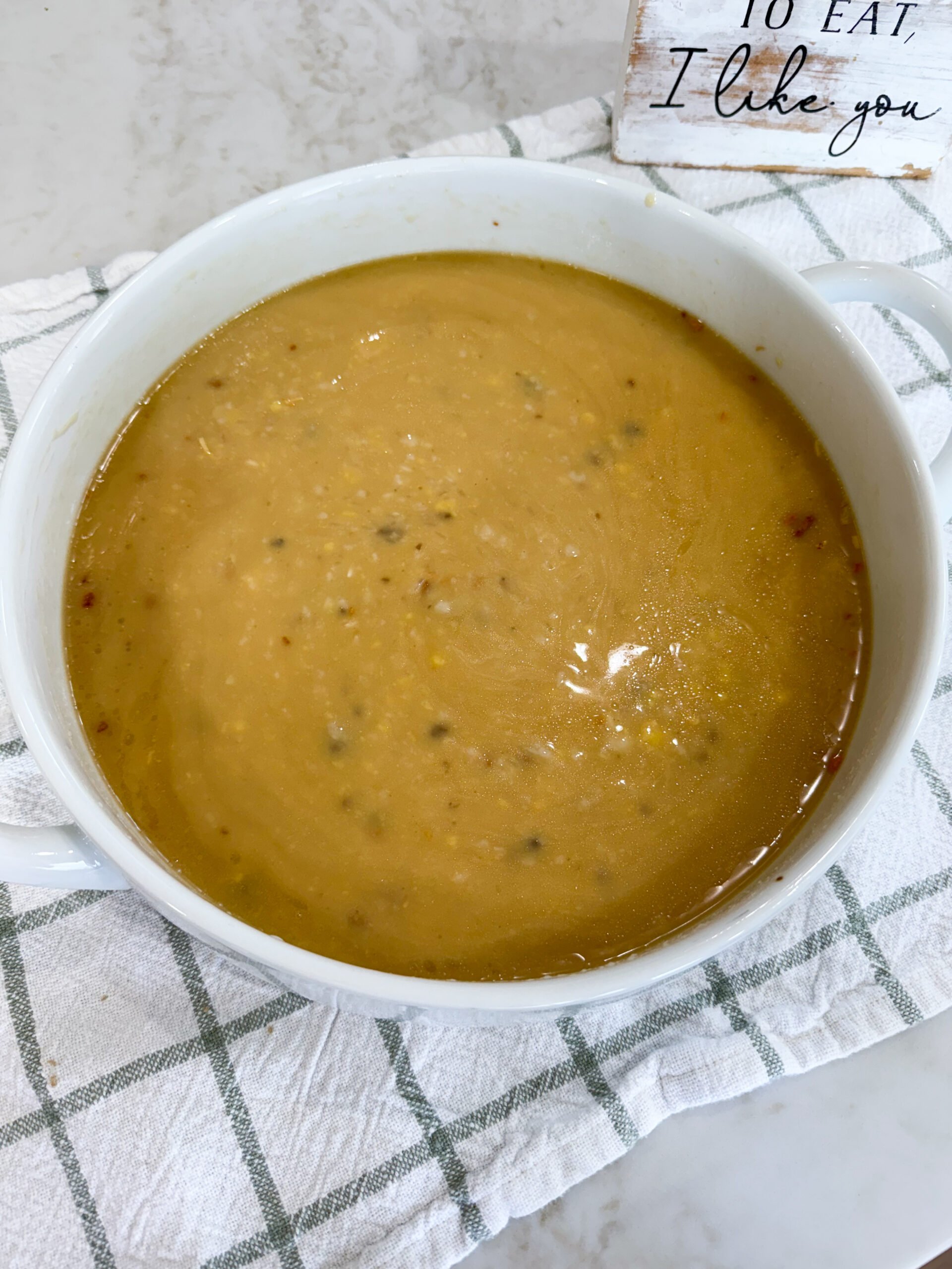 Rice, cream of mushroom soup, cream of chicken soup, broth, and onion soup mix whisked together in baking dish.