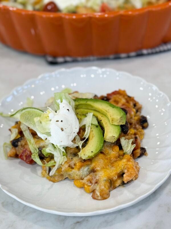 Fiesta chicken casserole baked with melted cheese and colorful toppings