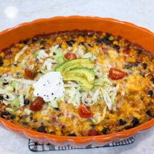 Fiesta chicken casserole baked with melted cheese and colorful toppings