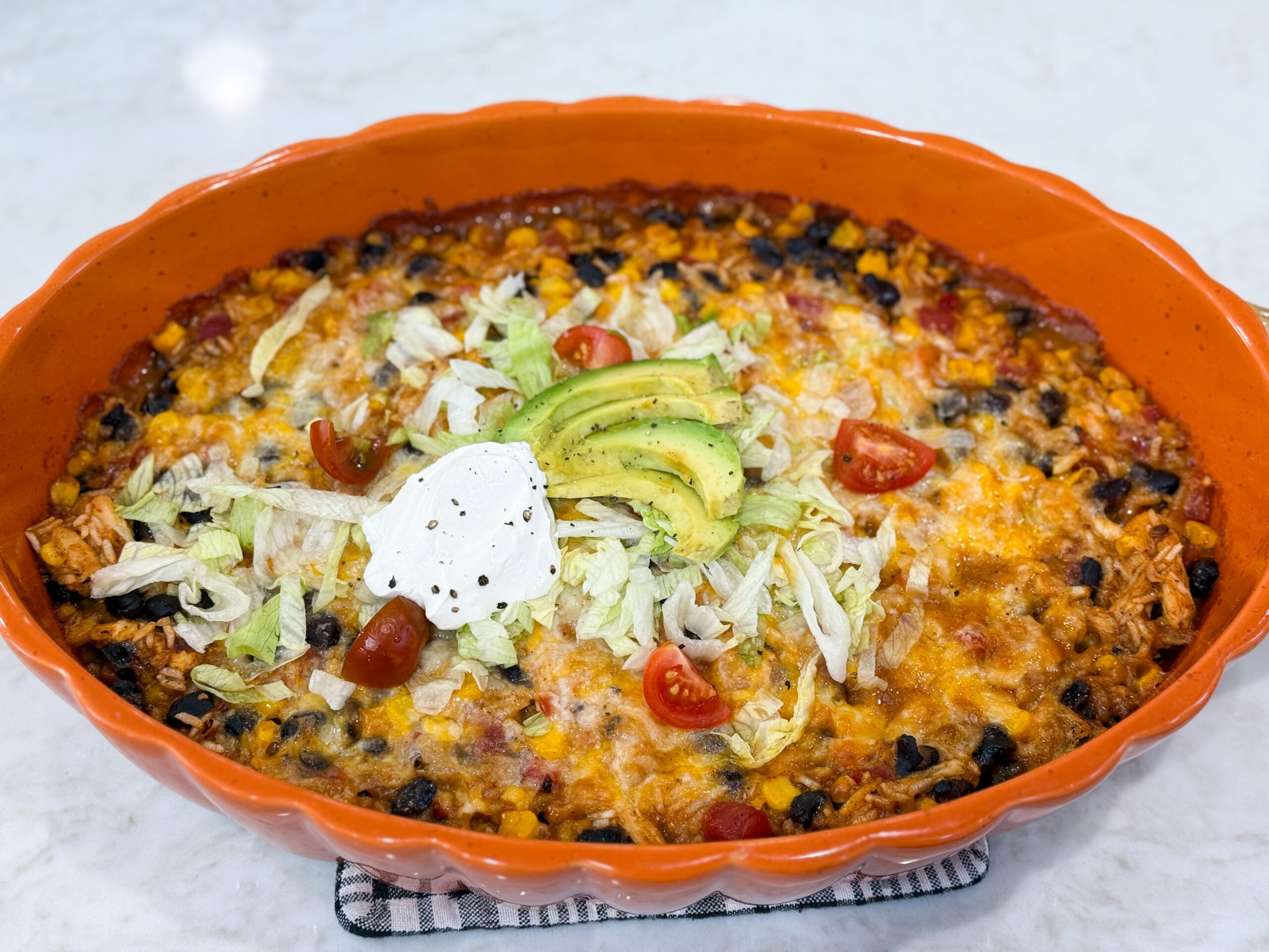 Fiesta chicken casserole baked with melted cheese and colorful toppings