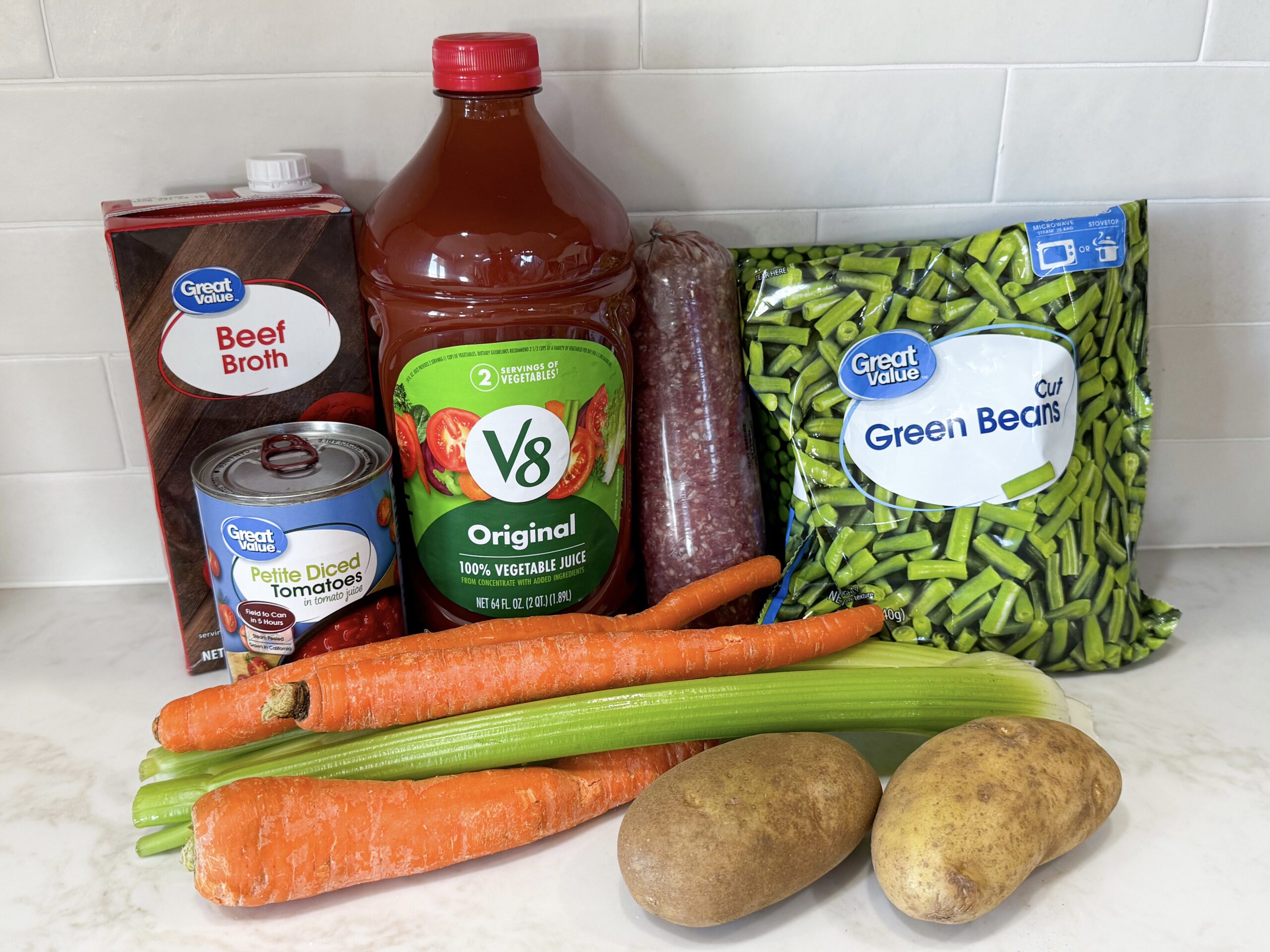 Ingredients for vegetable soup including ground beef, potatoes, carrots, and green beans