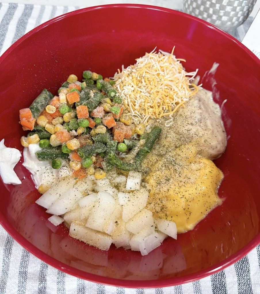 Stirring together creamy casserole ingredients before baking