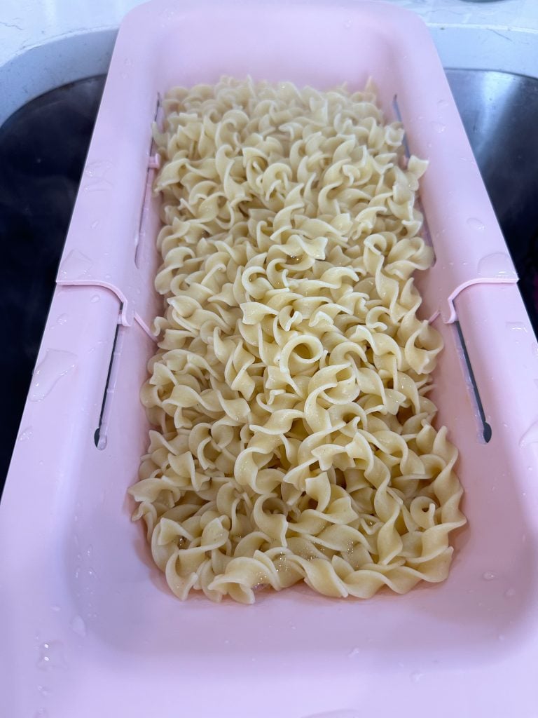 Eggs noodles raining in a colander.