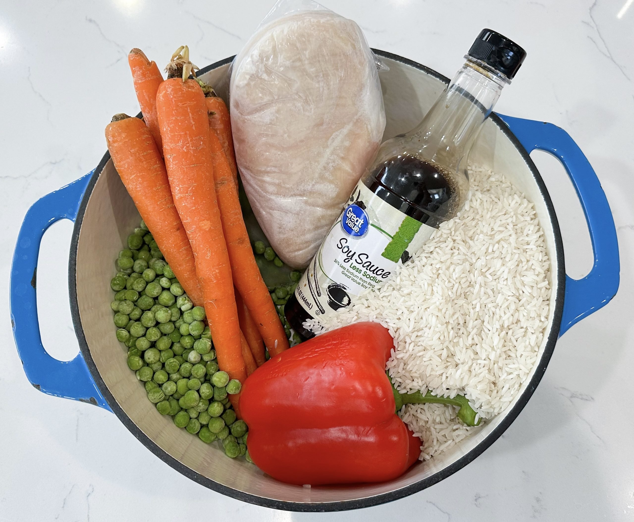 chicken, rice, vegetables, soy sauce, and honey in a dish