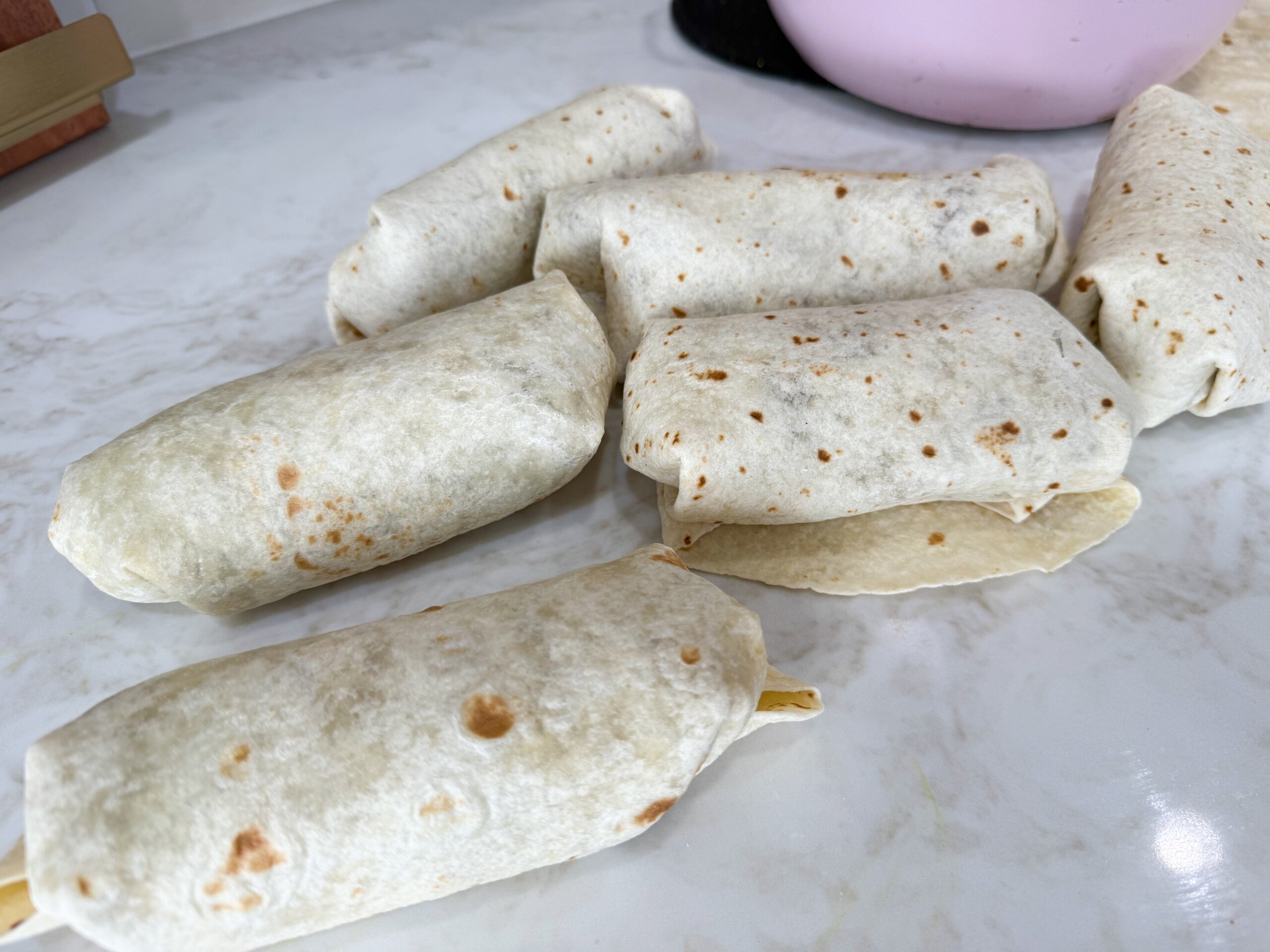 Lentil burritos rolled up on a counter top.
