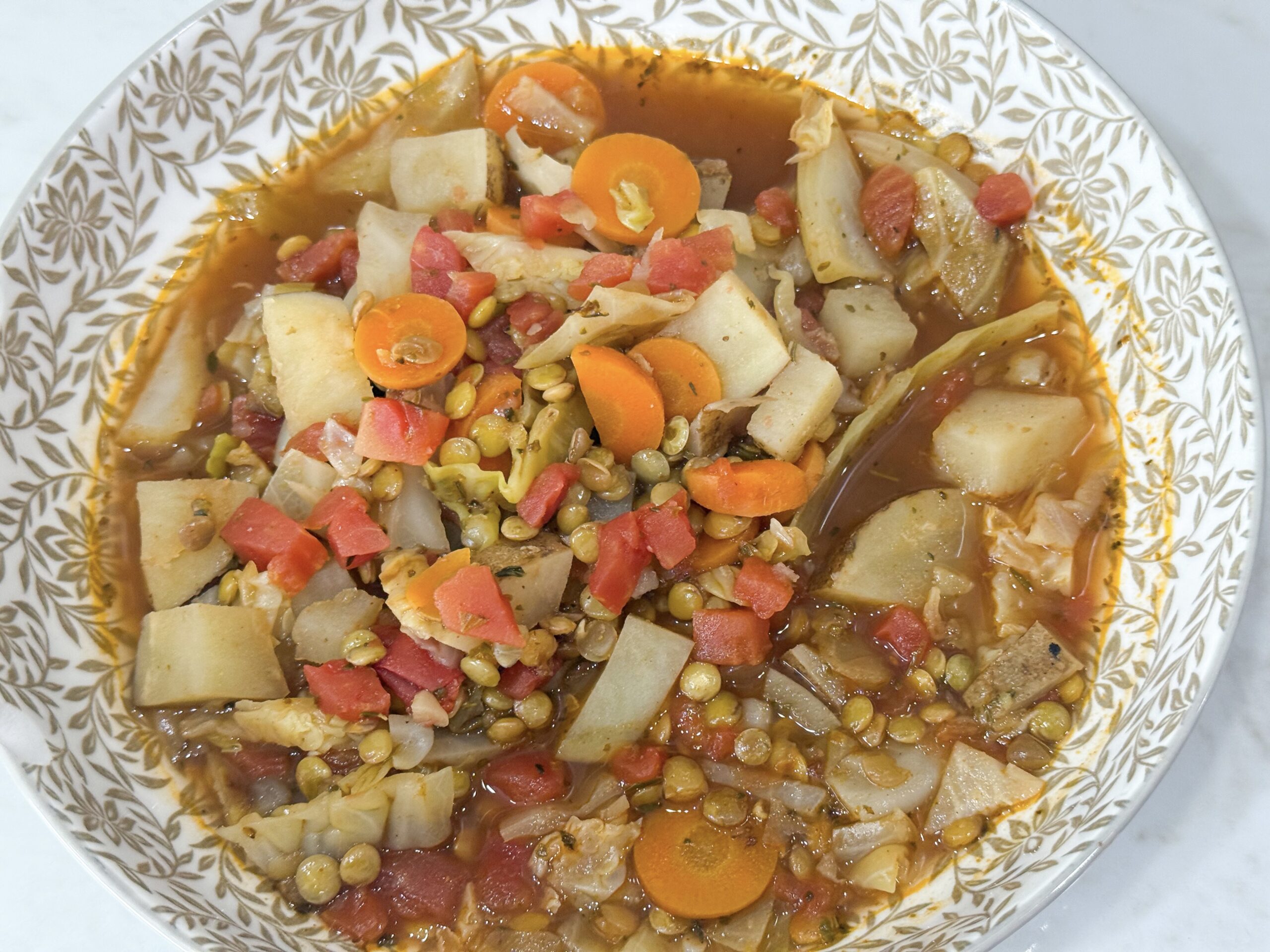 Cabbage and Lentils stew in a bowl. See meal plan for the full recipe.
