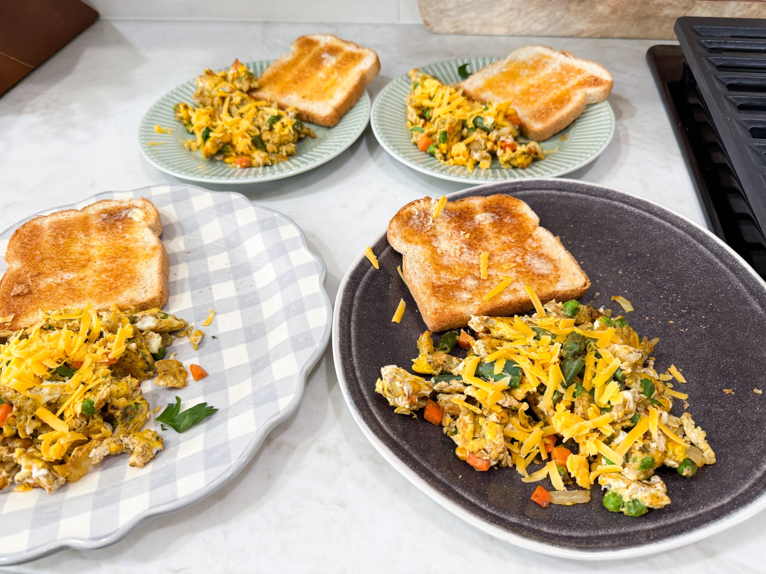 Four Egg and vegetable stiry fry plates with toast. Ready to serve four people. See meal plan for recipe.