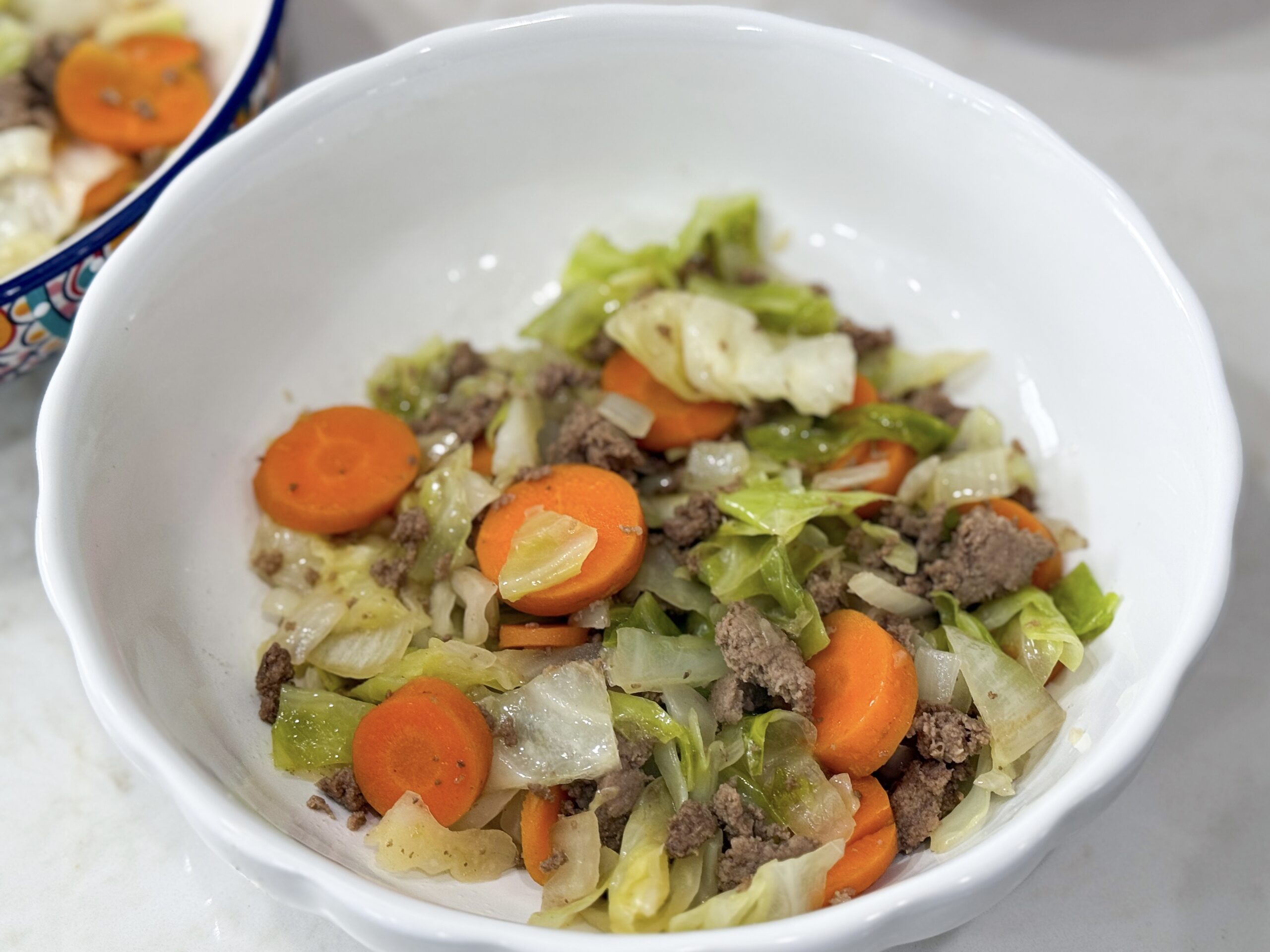 Ground turkey stir fry in a white bowl. See meal plan for recipe.