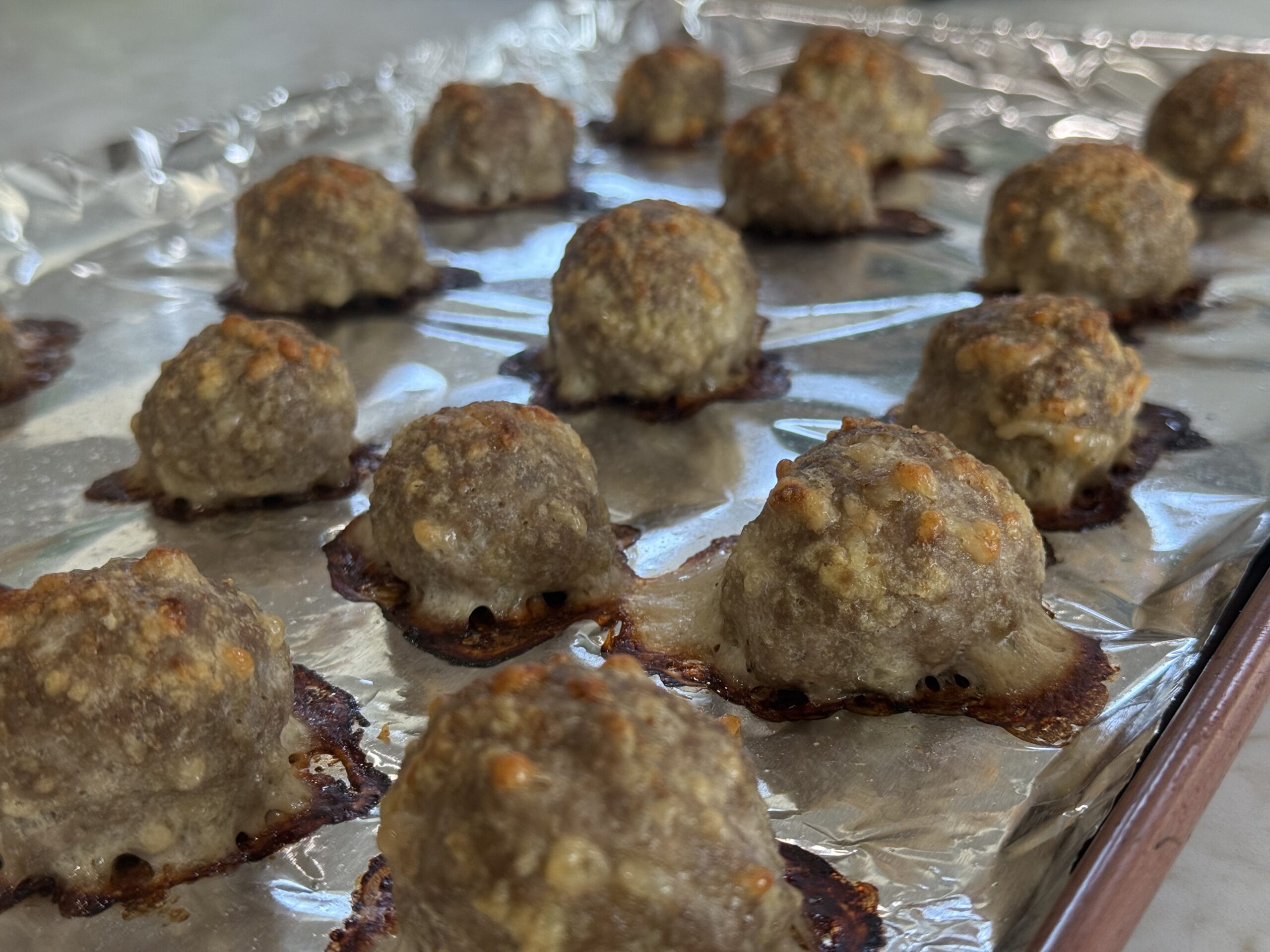 close up cooked turkey meatballs on baking sheet