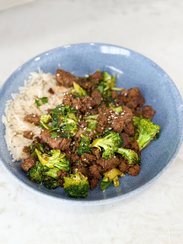 Cook Sweet & Spicy Turkey and Broccoli Bowl Recipe in a blue bowl on a white counter
