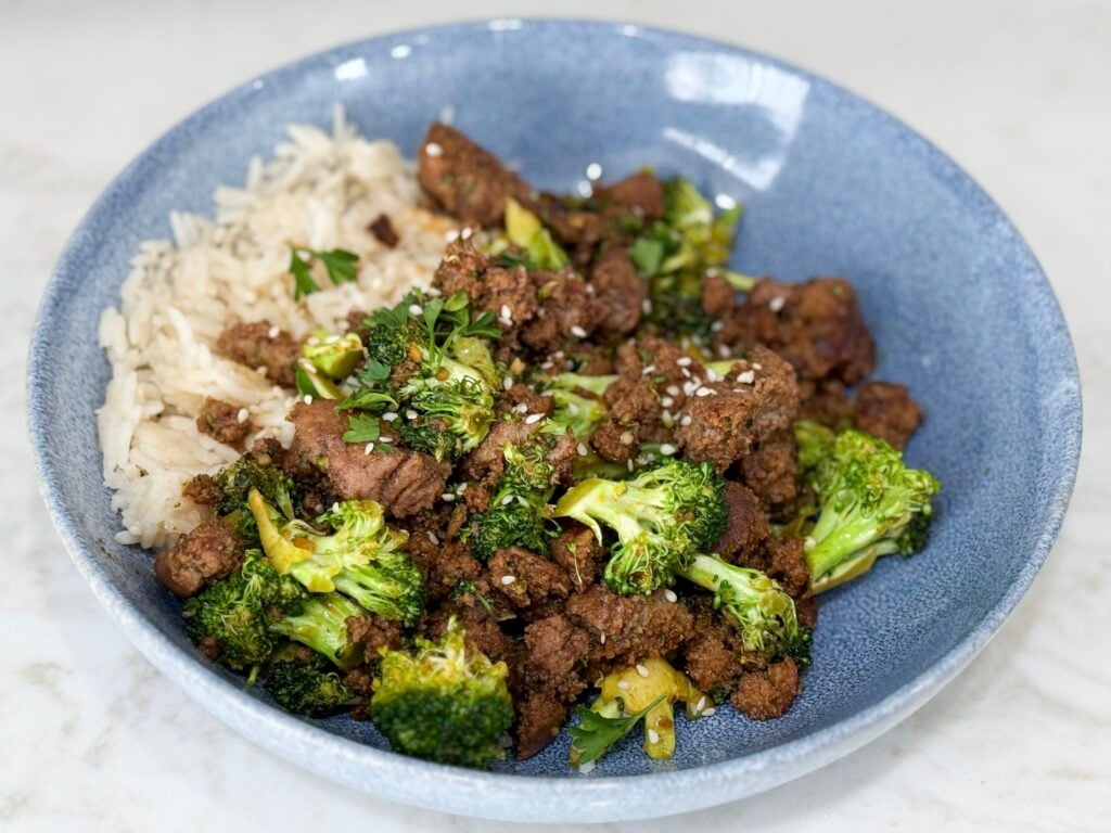 Cook Sweet & Spicy Turkey and Broccoli Bowl Recipe in a blue bowl on a white counter