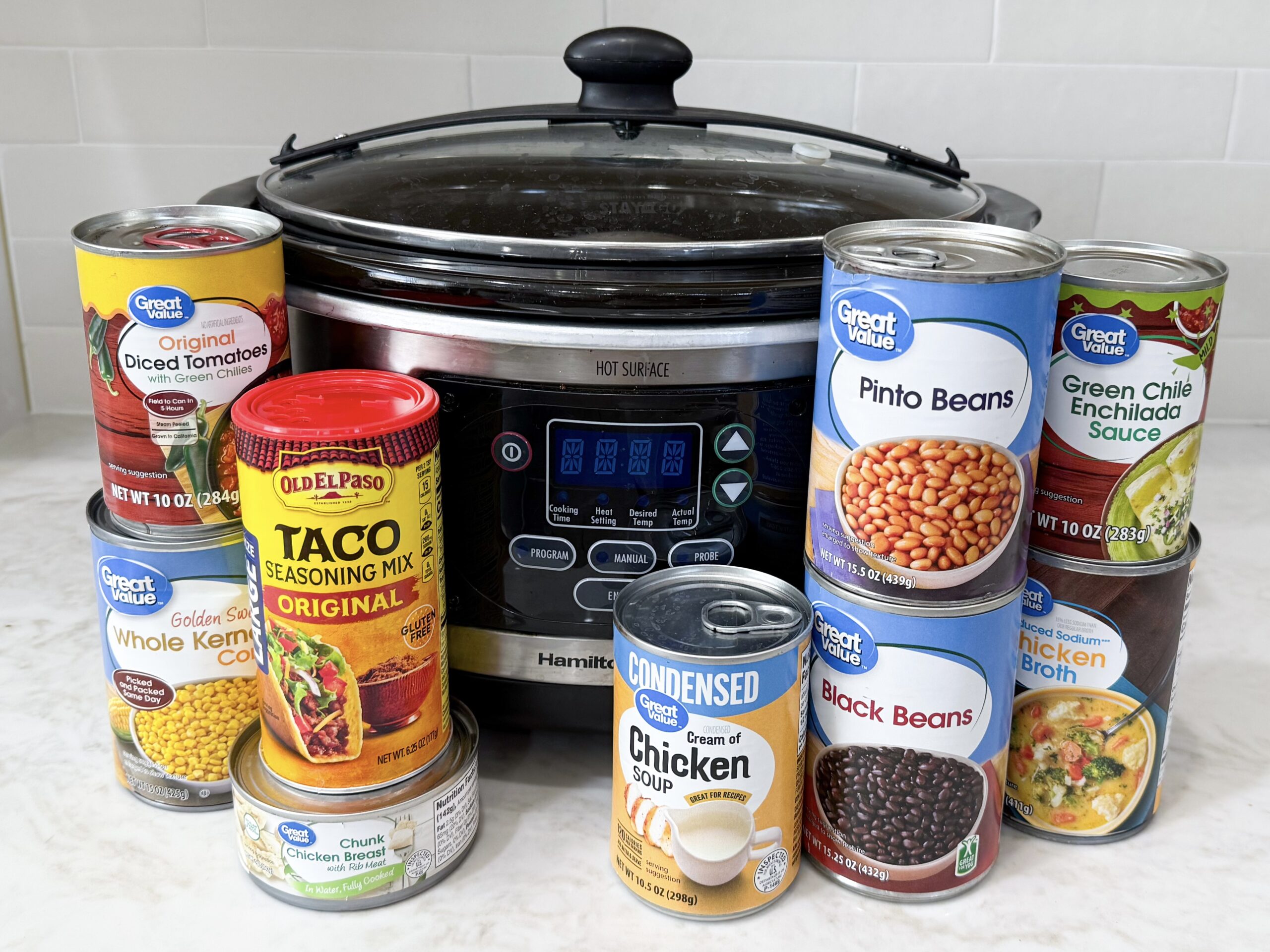 8 canned ingredients for taco soup lined up on countertop