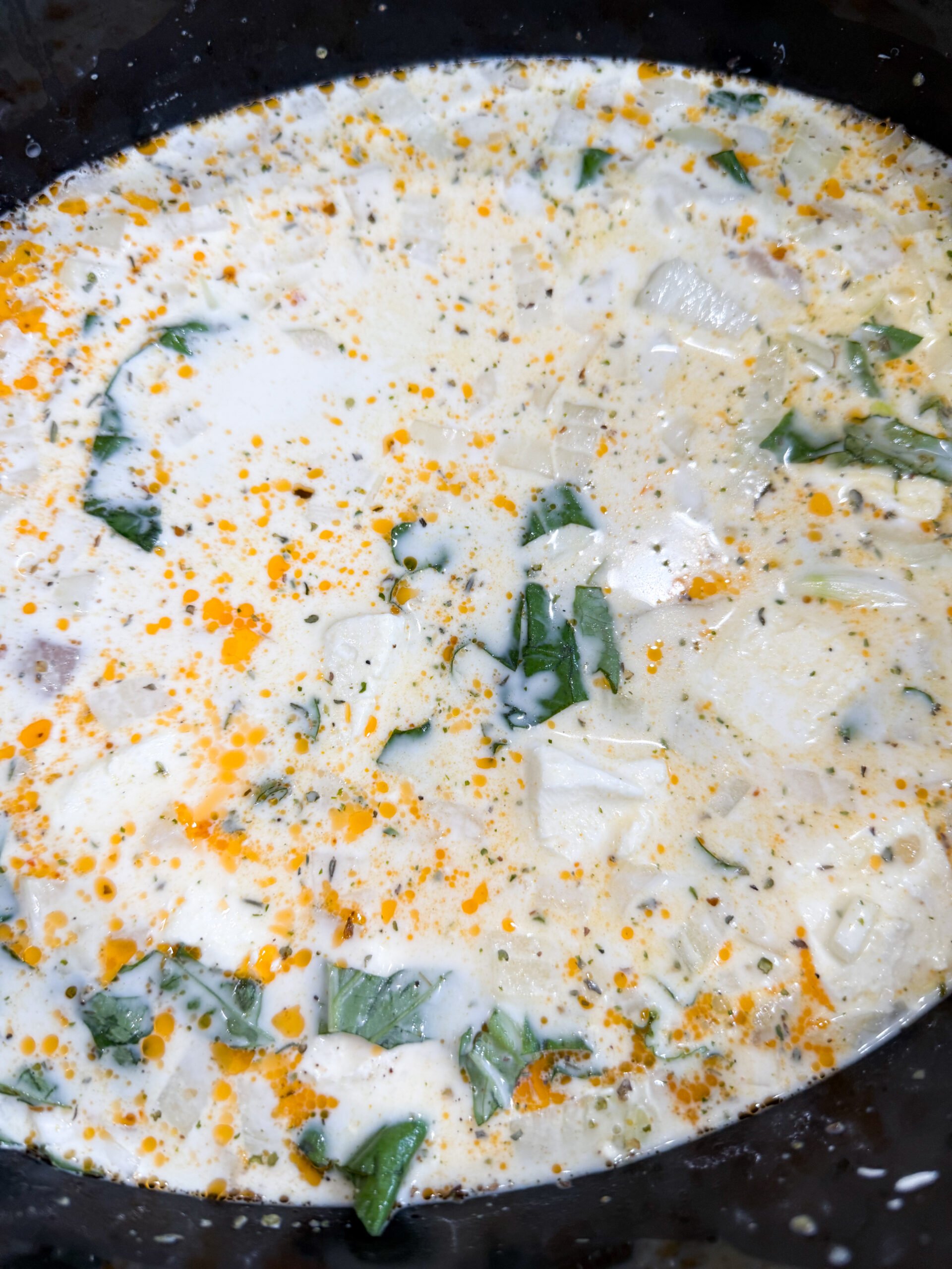 Chicken, cream cheese, and broth in slow cooker before cooking