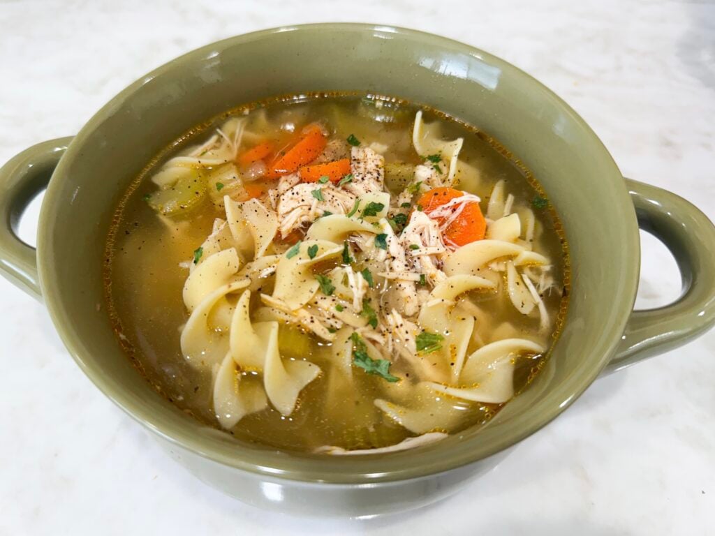 Finished Slow Cooker Chicken Noodle Soup garnished with parsley