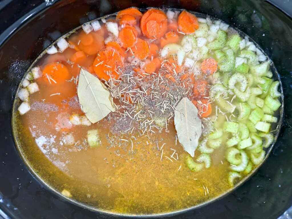 Vegetables and chicken in slow cooker before cooking