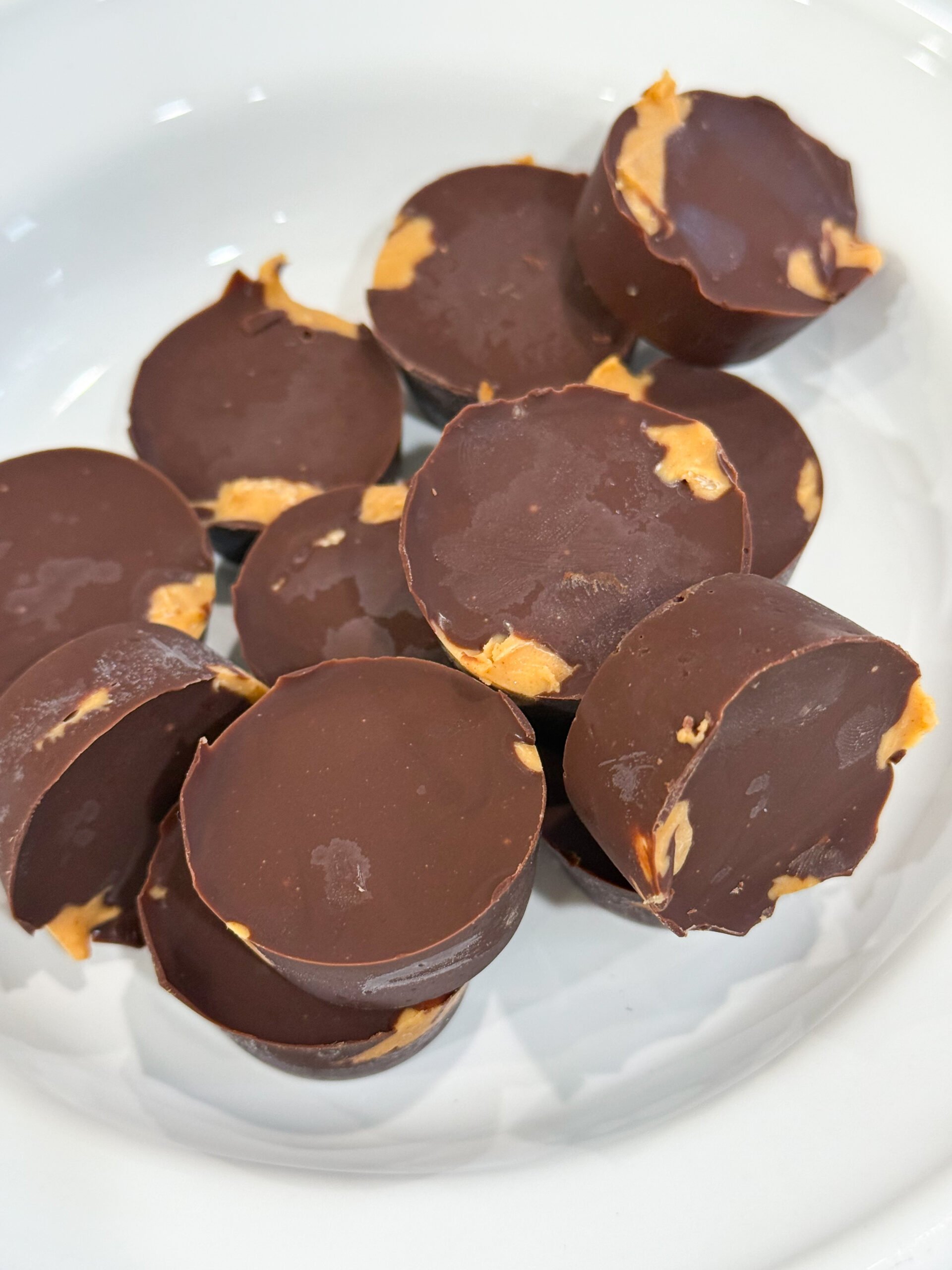 Homemade chocolate peanut butter cups in mini liners.