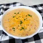 Finished Slow Cooker Ham and Potato Soup topped with cheddar and parsley
