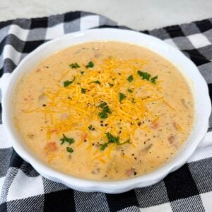 Finished Slow Cooker Ham and Potato Soup topped with cheddar and parsley