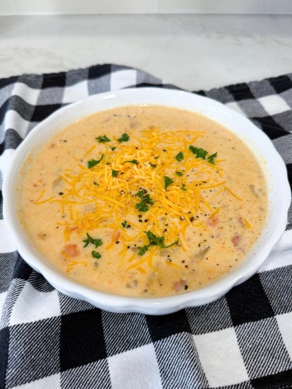 Finished Slow Cooker Ham and Potato Soup topped with cheddar and parsley