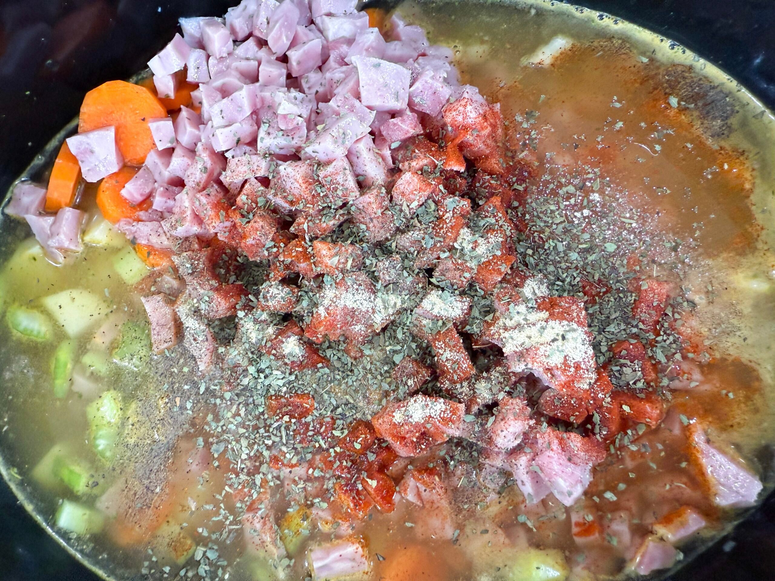 Vegetables, ham, and broth layered in slow cooker