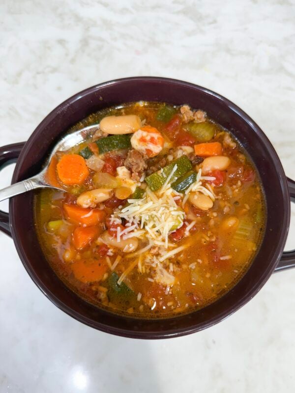 Bowl of Italian Vegetable and Sausage Soup topped with Parmesan