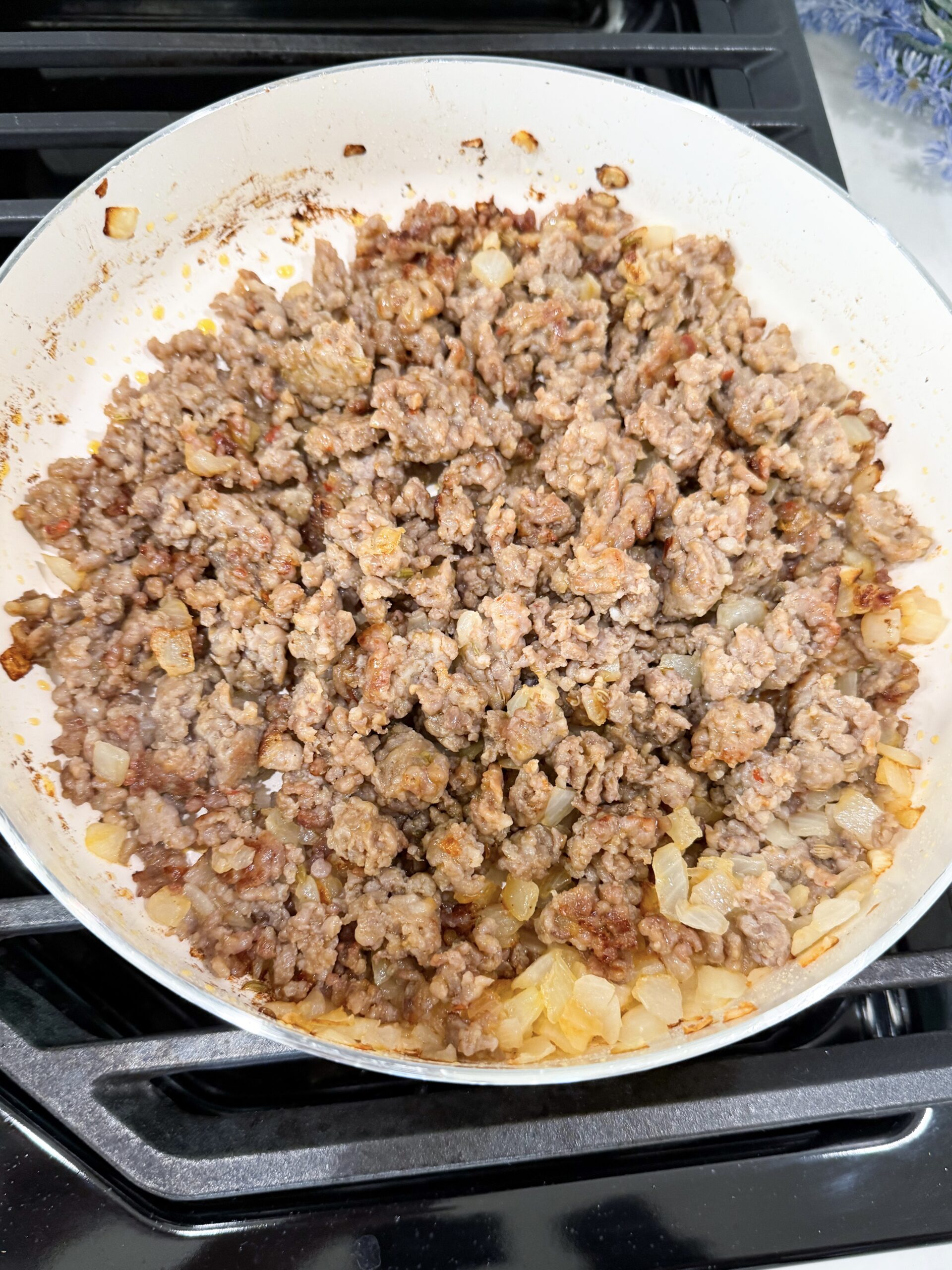 Sausage and onion browning in skillet