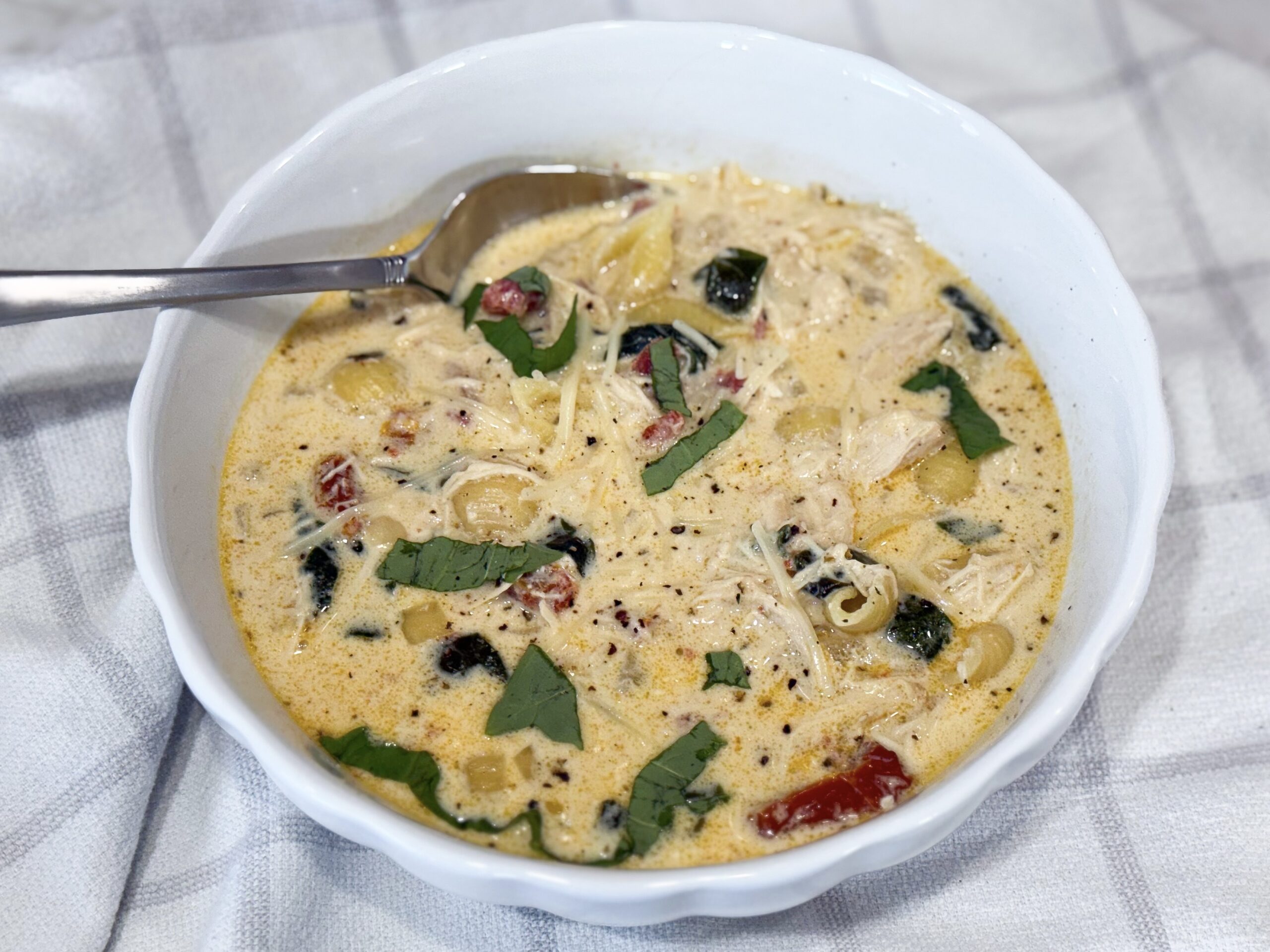 Slow Cooker Marry Me Chicken Soup with pasta and spinach — creamy, cozy, and family-friendly in a white bowl.