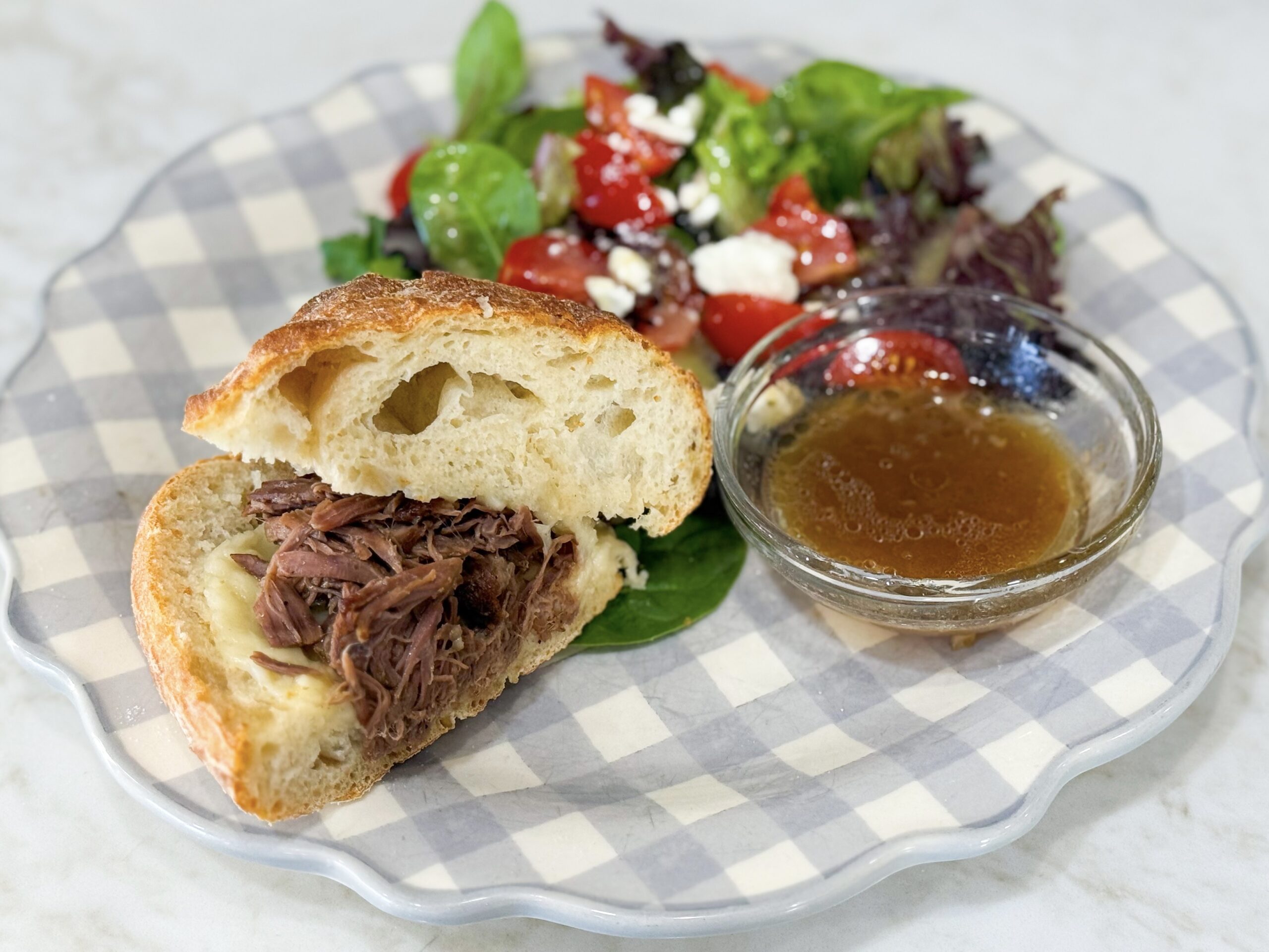 Pulled beef sandwiches with provolone cheese on soft buns.