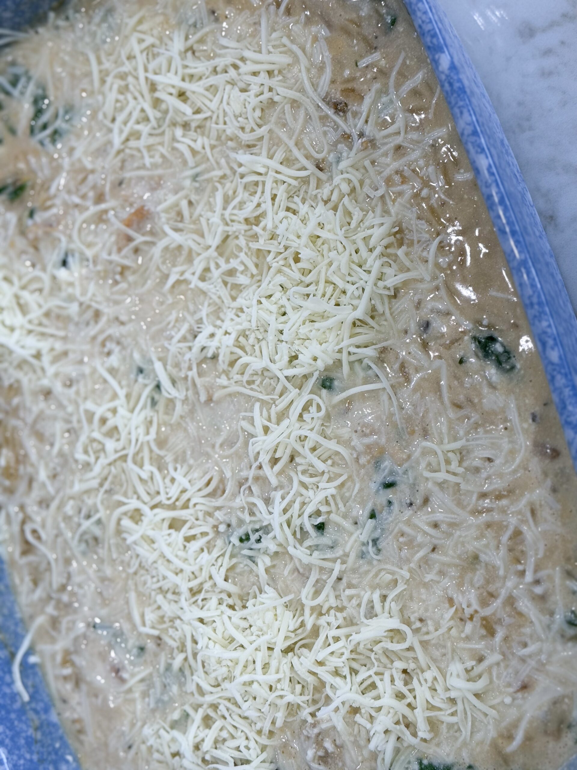 Shredded mozzarella sprinkled evenly over the casserole after baking.