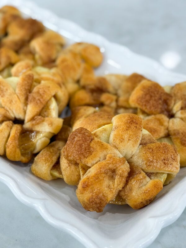 Golden baked apple crescent donuts dusted with powdered sugar