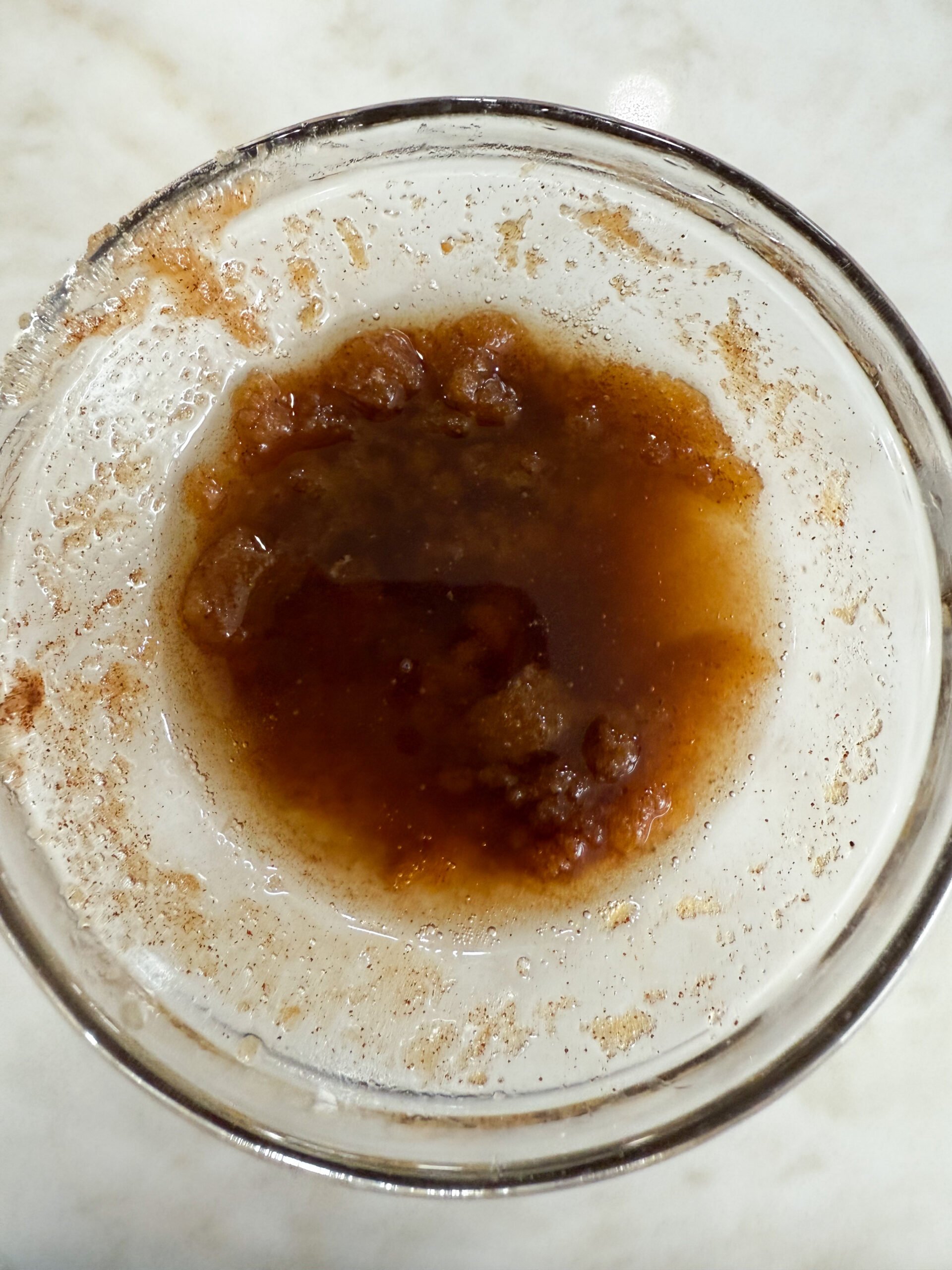 Melted butter, brown sugar, and cinnamon in a bowl for the donuts