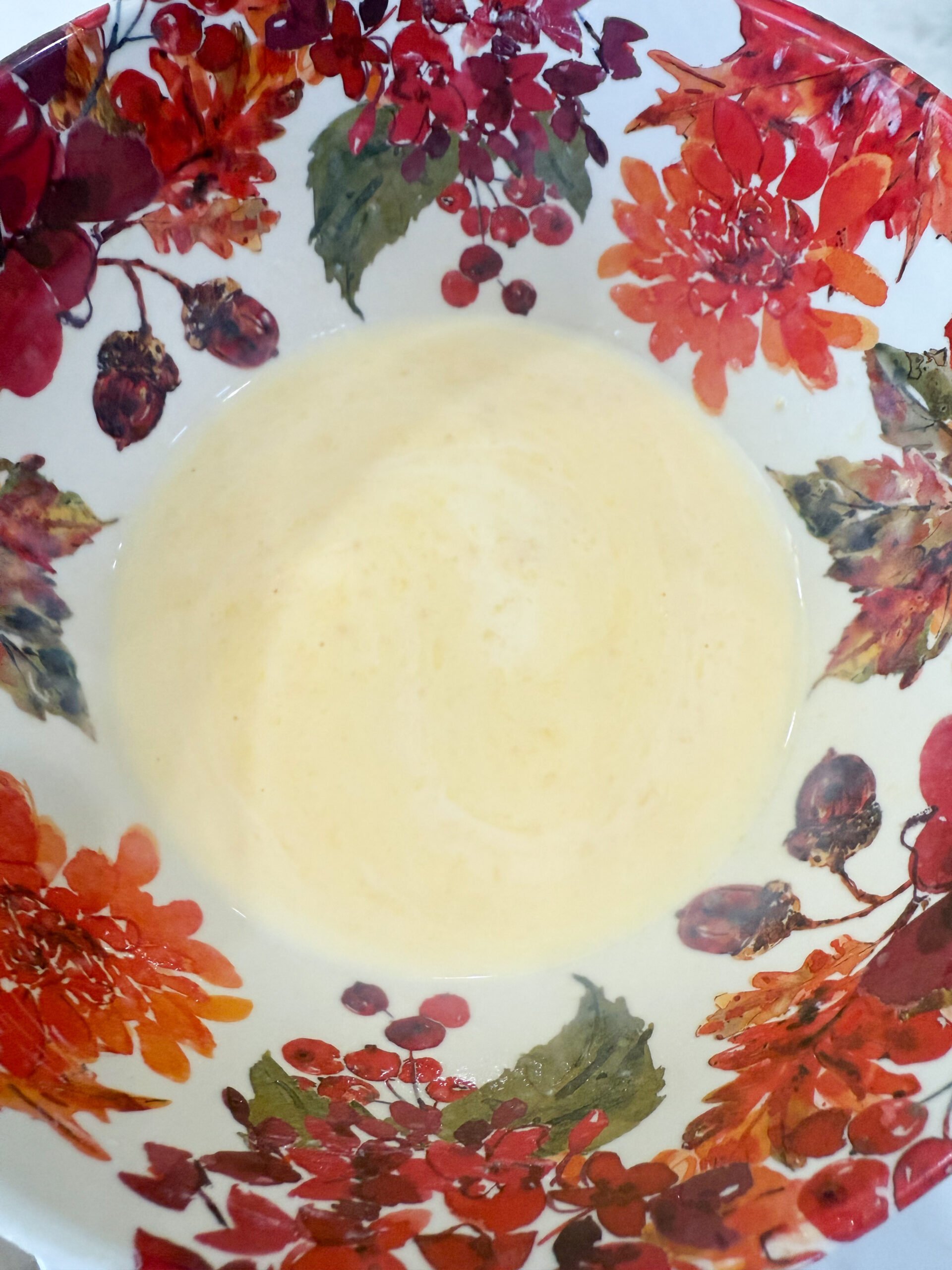 Chicken soup and milk wisked together in a bowl