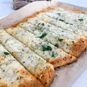 Golden baked cheesy garlic bread made with crescent dough on sheet pan