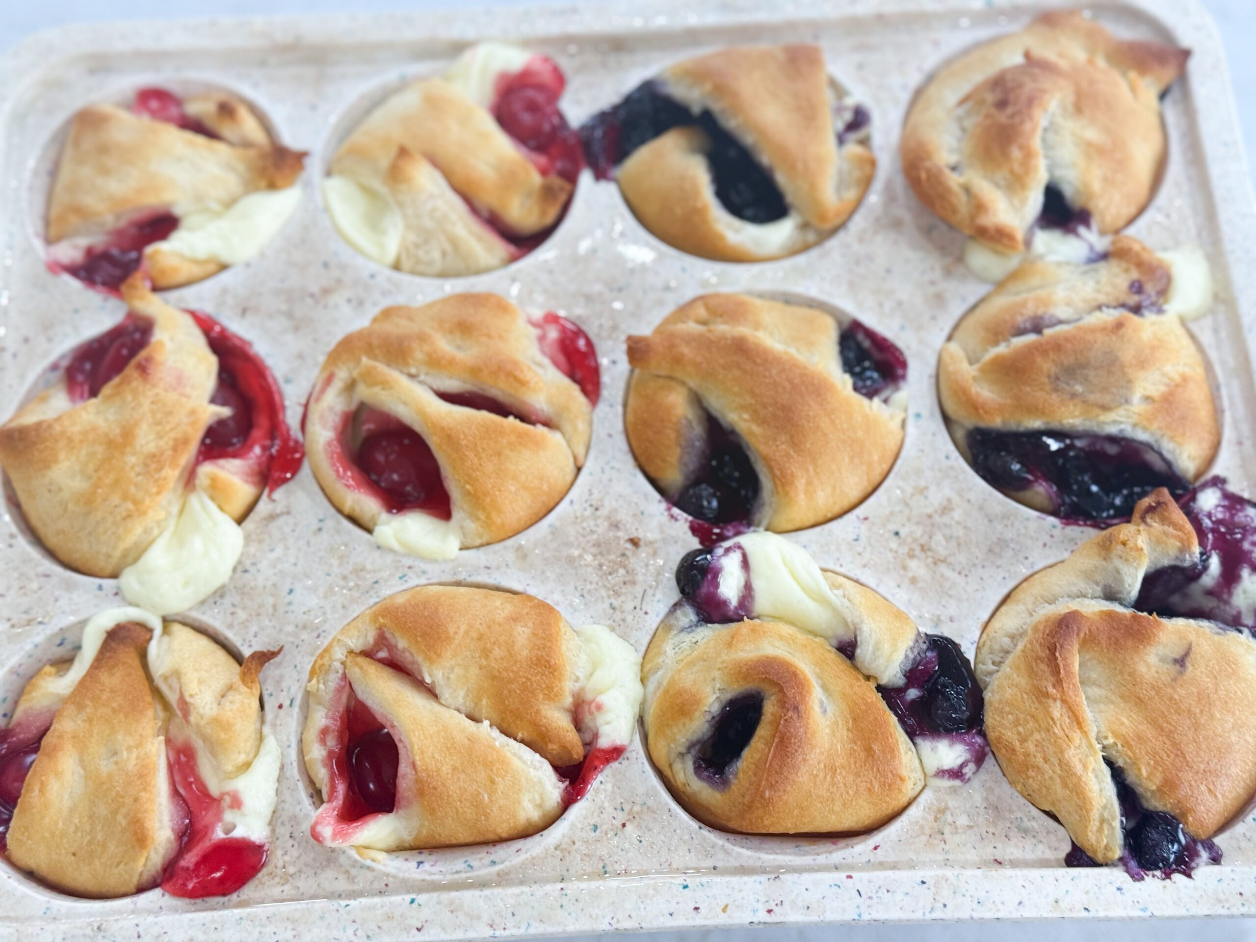 Golden mini cheesecake pies topped with fruit filling